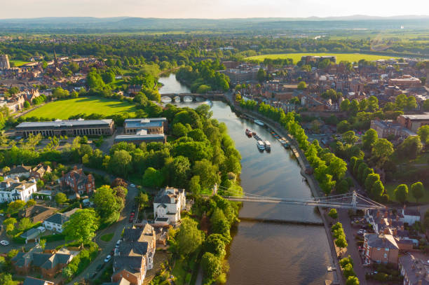 Aerial view of River Dee in Chester at dusk including Queens Park Bridge and The Old Dee Bridge, Cheshire, England, UK